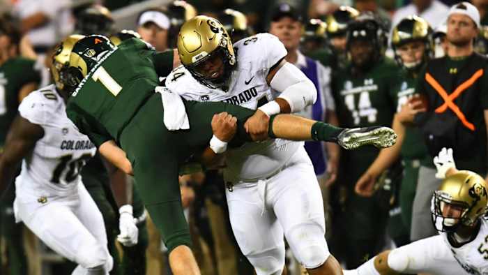 Colorado Buffaloes defensive lineman Mustafa Johnson (34) sacks Colorado State Rams quarterback K.J. Carta-Samuels (1) in the first quarter at Broncos Stadium at Mile High.